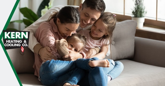 Adult and kids sitting on couch.
