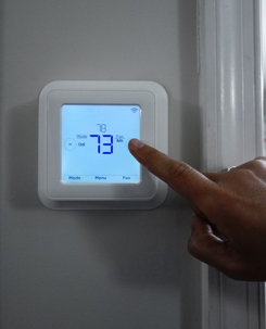 Person touching their thermostat