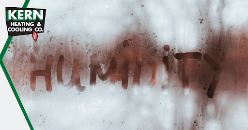 The word humidity written on a window with condensation.